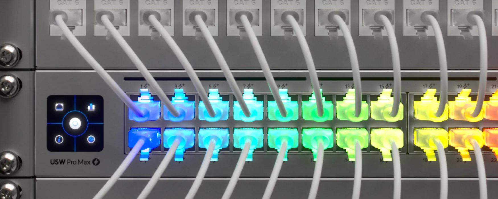 A row of patch cables plugged into a UniFi switch, each port lit a different color