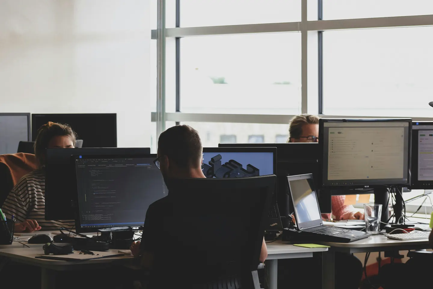 Staff working at their computers in a bright open office