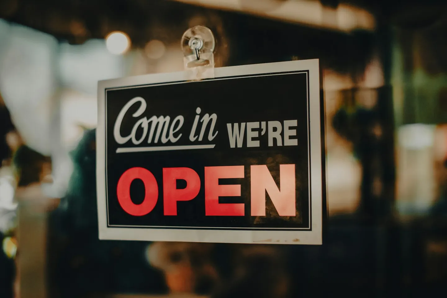 A sign on a shop door that reads Come in, we are open
