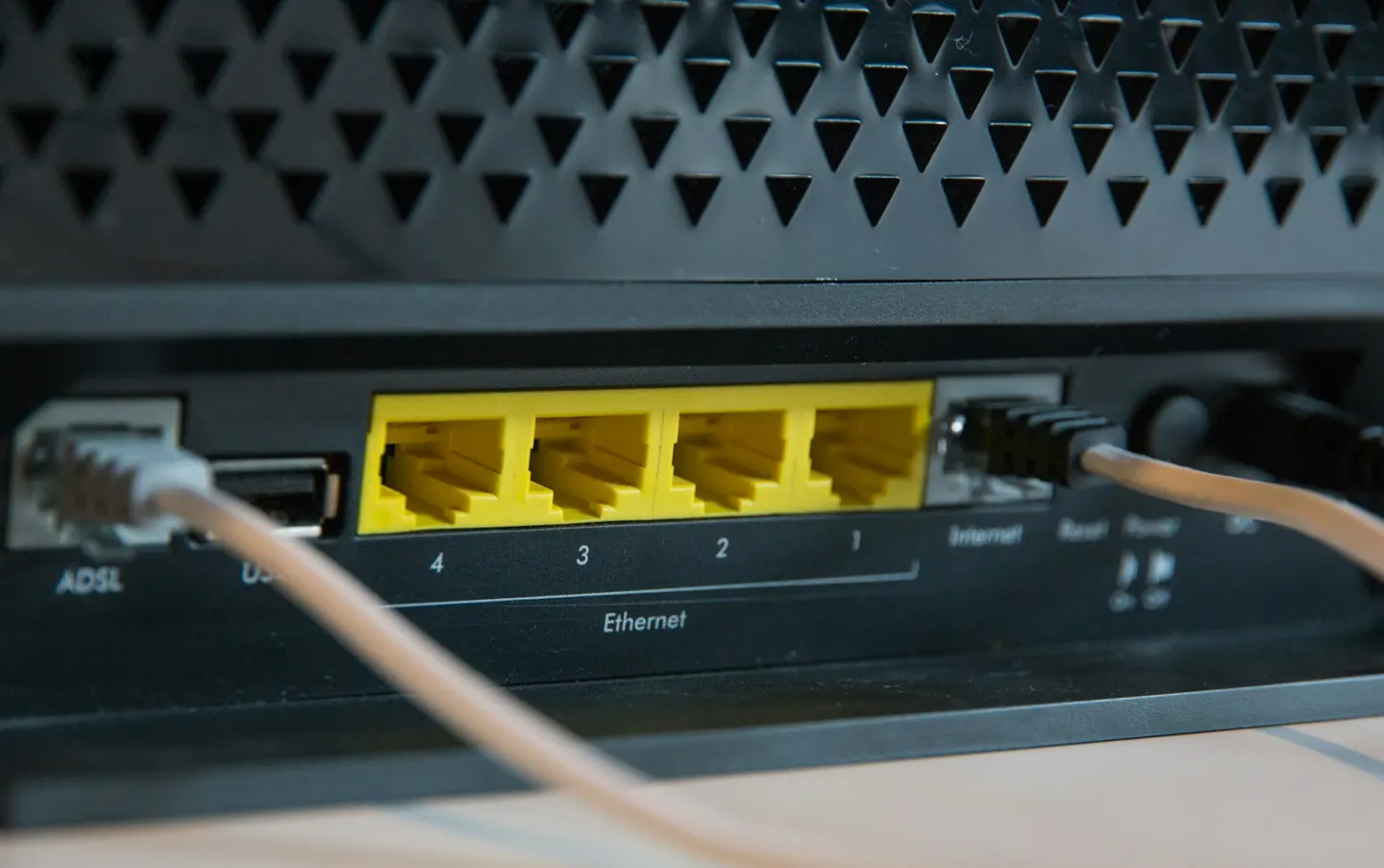 Ethernet cables plugged into the back of a router