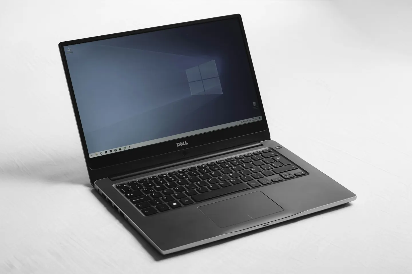 A Windows laptop open on a white table